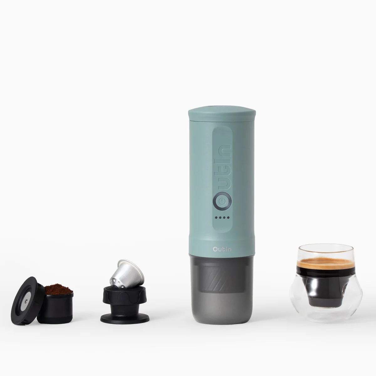 Canyon Green OutIn Nano 2 beside its ground-coffee basket, capsule adapter and a glass of espresso